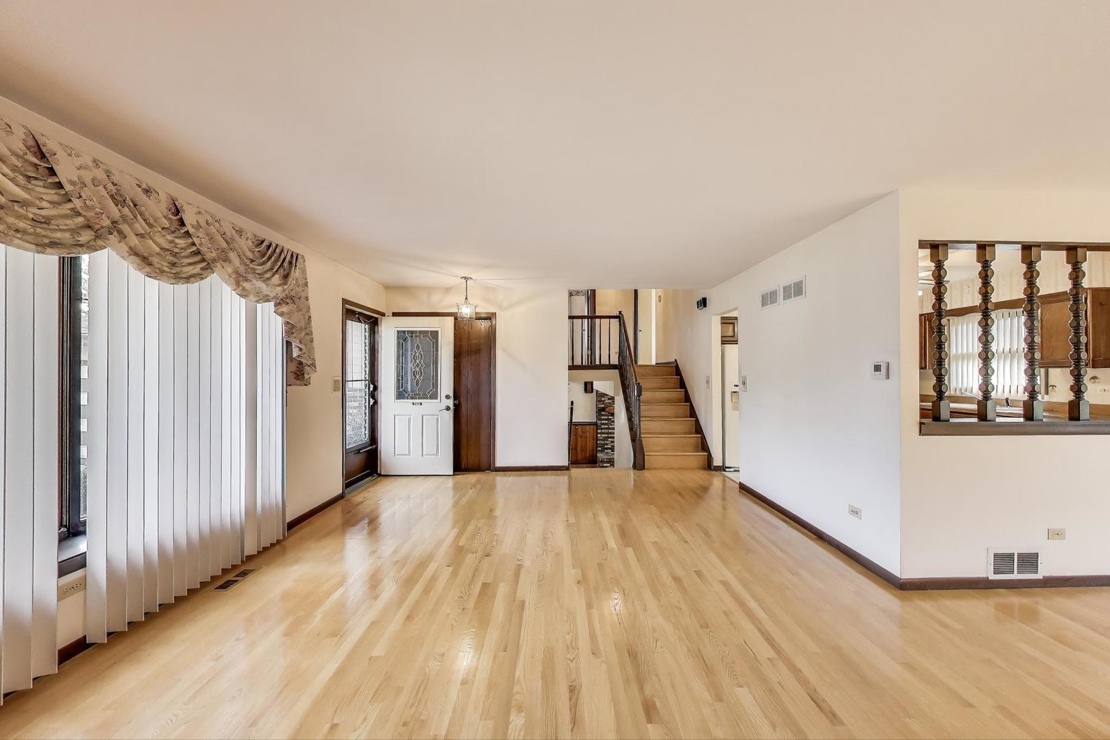 700 Noah Terrace Mount Prospect, IL 60056 - Photo 6 of 35 a view of a hallway with wooden floors and stairs