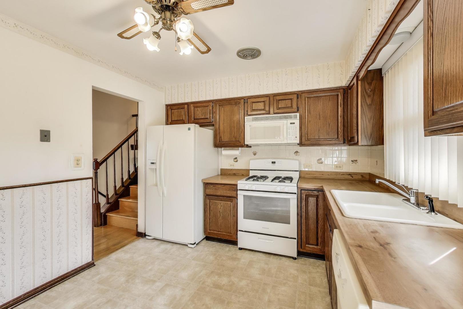 700 Noah Terrace Mount Prospect, IL 60056 - Photo 10 of 35 a kitchen with a sink cabinets and appliances