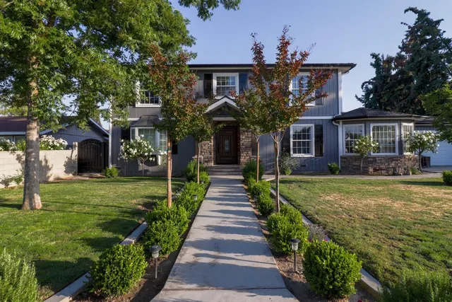 a front view of a house with a garden