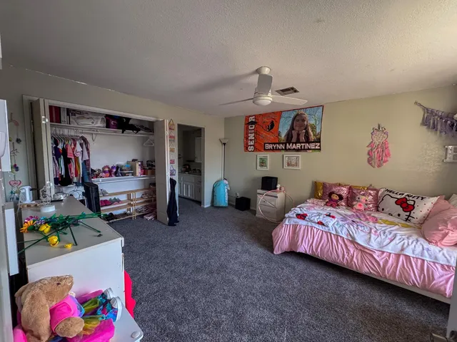 a bedroom with bed and furniture