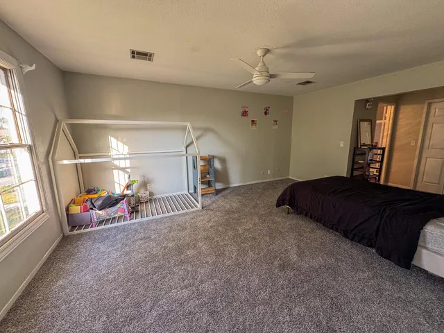 a bedroom with a bed and a window