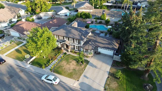an aerial view of a house with garden space and street view