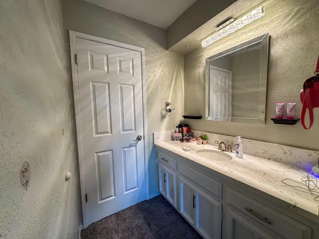 a bathroom with a double vanity sink and a mirror