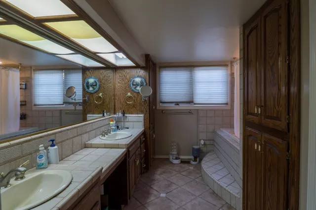 a bathroom with a sink double vanity granite and a mirror