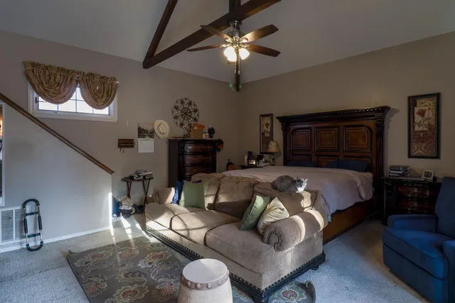 a bedroom with a bed furniture and lamp