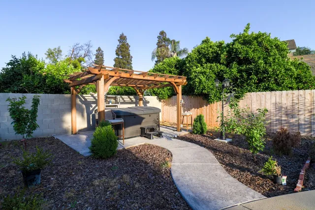 a view of a patio with furniture and a garden