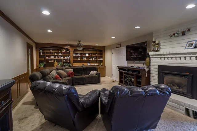 a living room with fireplace furniture and a flat screen tv