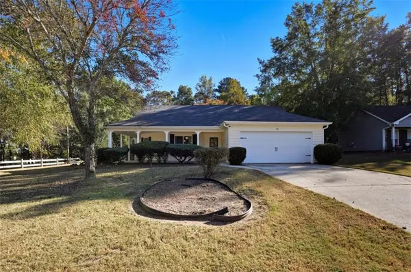 a view of a house with backyard and sitting area