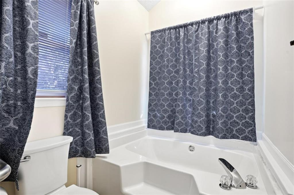 15 Beaverdam Lane Covington, GA 30016 - Photo 13 of 24 a bathroom with a bathtub and shower