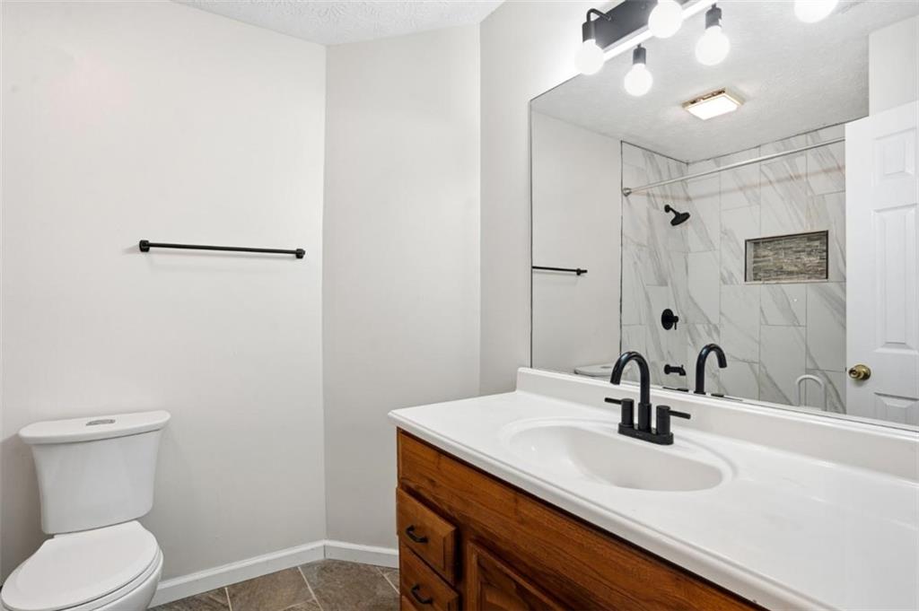 15 Beaverdam Lane Covington, GA 30016 - Photo 14 of 24 a bathroom with a sink a toilet and mirror