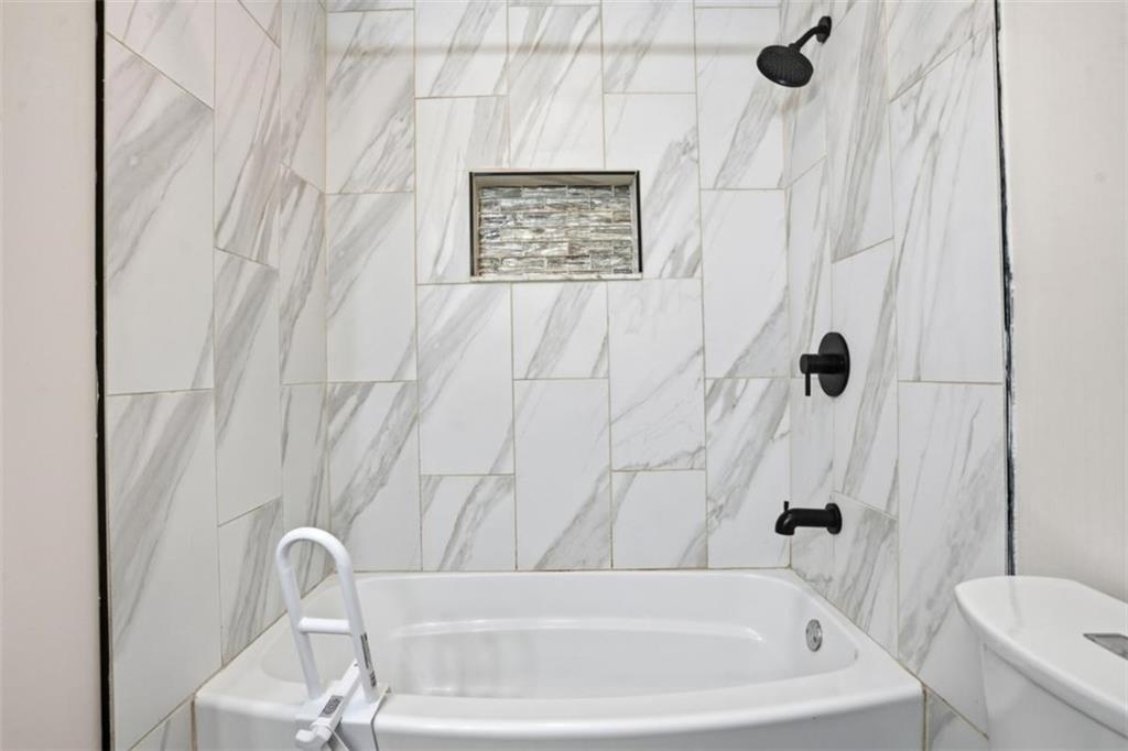 15 Beaverdam Lane Covington, GA 30016 - Photo 15 of 24 a bathroom with a bath tub and a shower