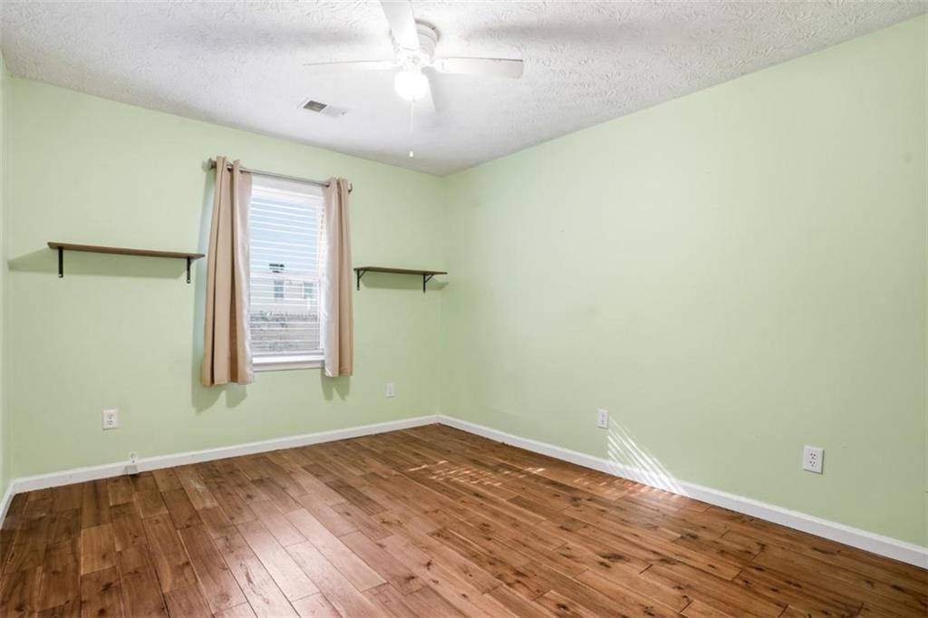 15 Beaverdam Lane Covington, GA 30016 - Photo 16 of 24 an empty room with wooden floor closet and windows