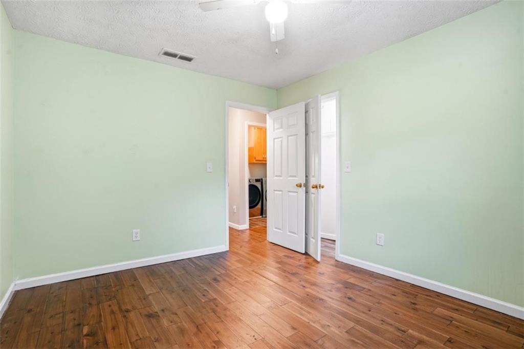 15 Beaverdam Lane Covington, GA 30016 - Photo 17 of 24 an empty room with wooden floor and windows