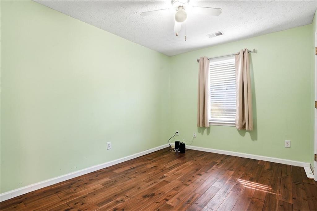 15 Beaverdam Lane Covington, GA 30016 - Photo 18 of 24 an empty room with wooden floor and windows