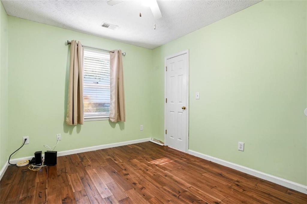 15 Beaverdam Lane Covington, GA 30016 - Photo 19 of 24 an empty room with wooden floor and windows