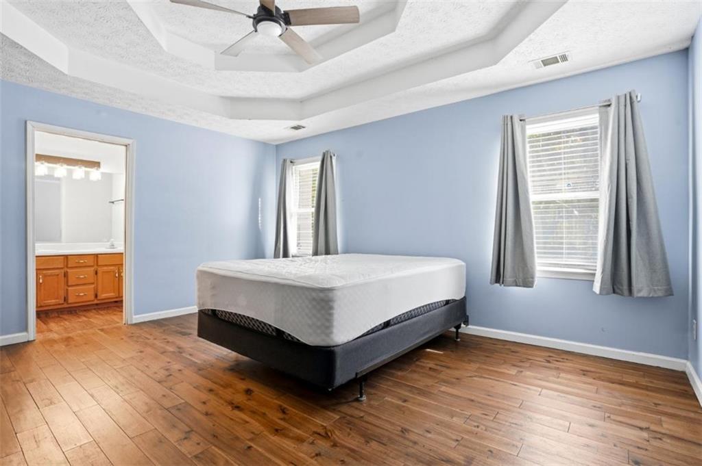 15 Beaverdam Lane Covington, GA 30016 - Photo 23 of 24 a spacious bedroom with a bed and wooden floor