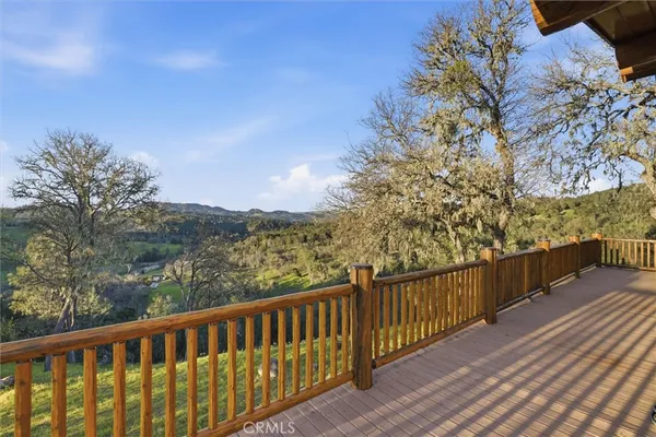 a view of a balcony with wooden fence