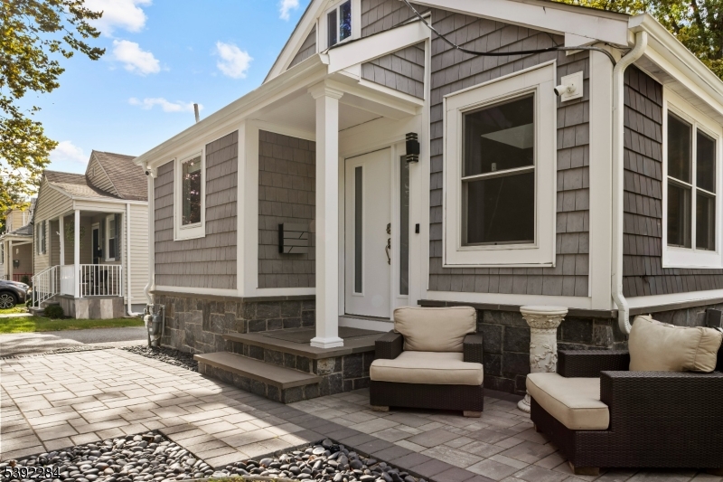 a view of a house with a couches and lounge chair