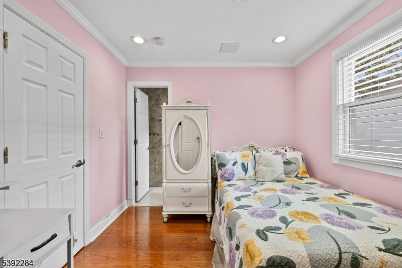 298 4th Avenue Hawthorne, NJ 07506 - Photo 13 of 26 a bedroom with a bed a mirror and furniture