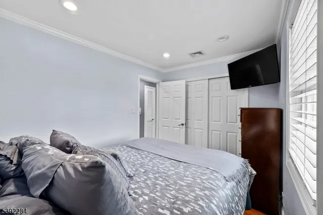 a bedroom with a bed and a television