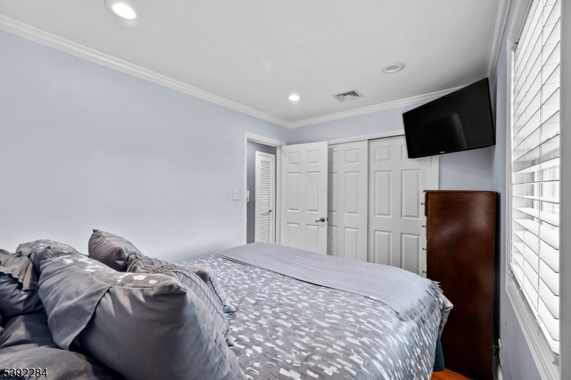 298 4th Avenue Hawthorne, NJ 07506 - Photo 15 of 26 a bedroom with a bed and a television