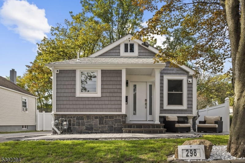 298 4th Avenue Hawthorne, NJ 07506 - Photo 2 of 26 a front view of a house with a yard