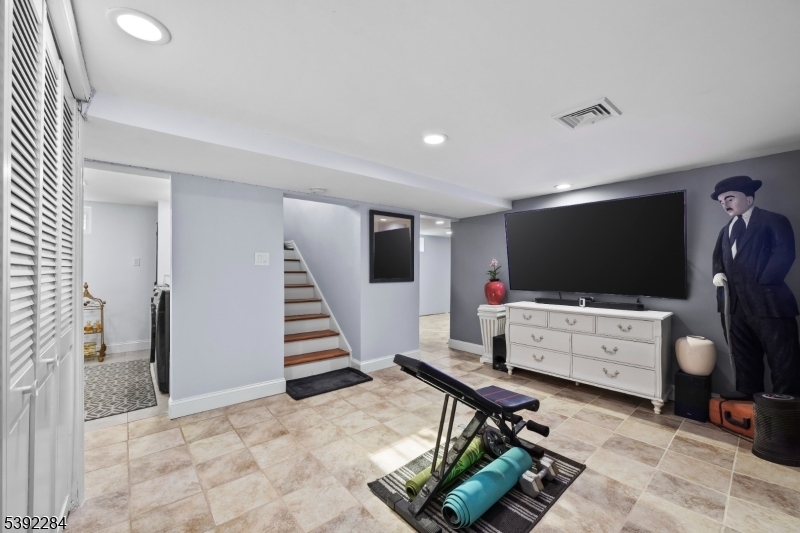 298 4th Avenue Hawthorne, NJ 07506 - Photo 21 of 26 a living room with furniture and a flat screen tv