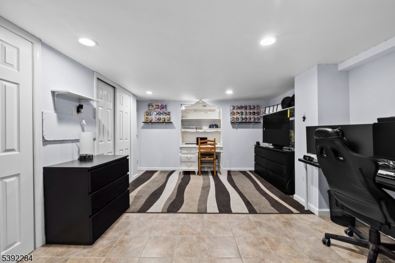298 4th Avenue Hawthorne, NJ 07506 - Photo 25 of 26 a kitchen with refrigerator and chairs