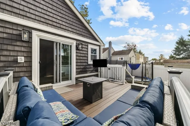 a view of a deck with couches floor to ceiling window with wooden floor