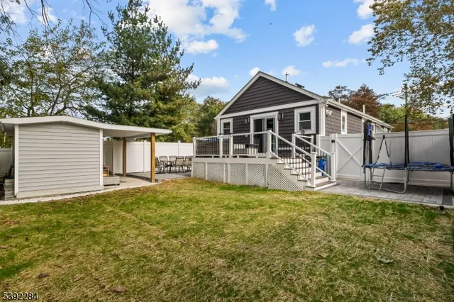 a view of a house with a yard and sitting area