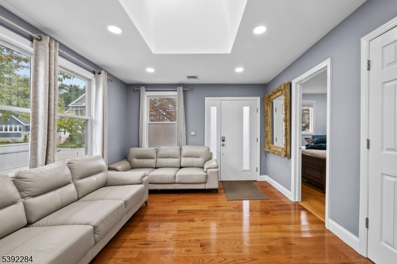 298 4th Avenue Hawthorne, NJ 07506 - Photo 9 of 26 a living room with furniture and a rug