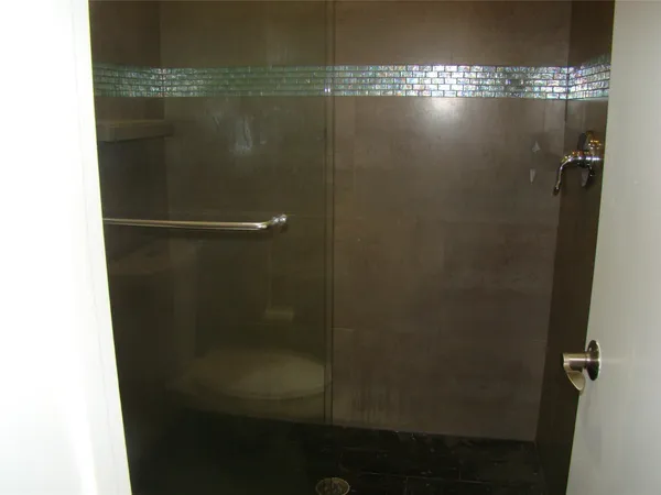 a bathroom with a glass shower door