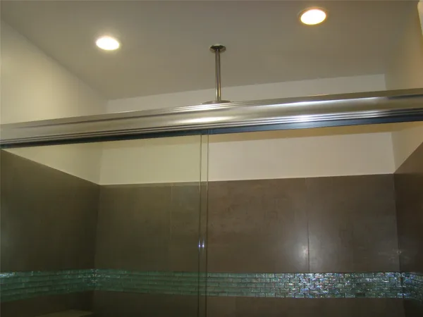 a bathroom with a glass door shower
