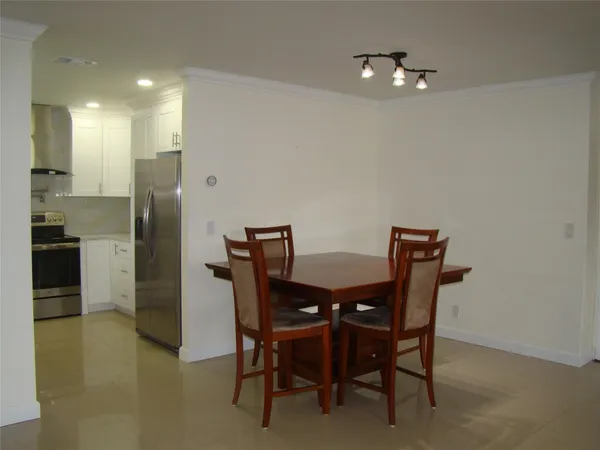a room with furniture pool table and windows