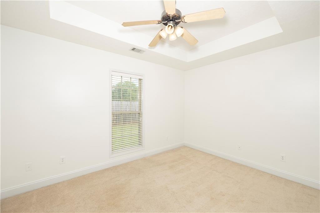 8 Ridgebrook Drive Phenix City, AL 36869 - Photo 17 of 21 Unfurnished room with a raised ceiling, light carpet, and a ceiling fan