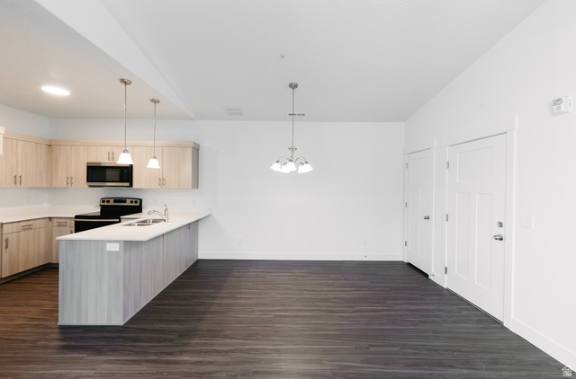 4655 South 720 West, Unit I304 Mapleton, UT 84664 - Photo 14 of 16 Kitchen with light wood finish cabinets, a peninsula, stainless steel appliances, and hanging lights