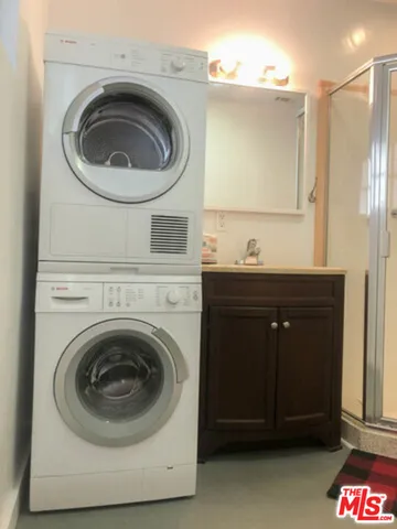a utility room with a sink dryer and washer
