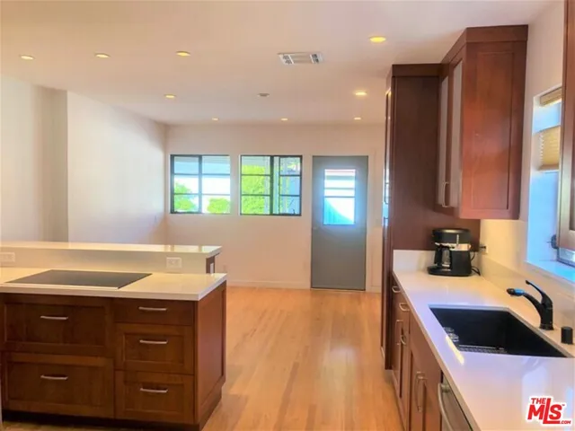 a kitchen with a sink stove and cabinets