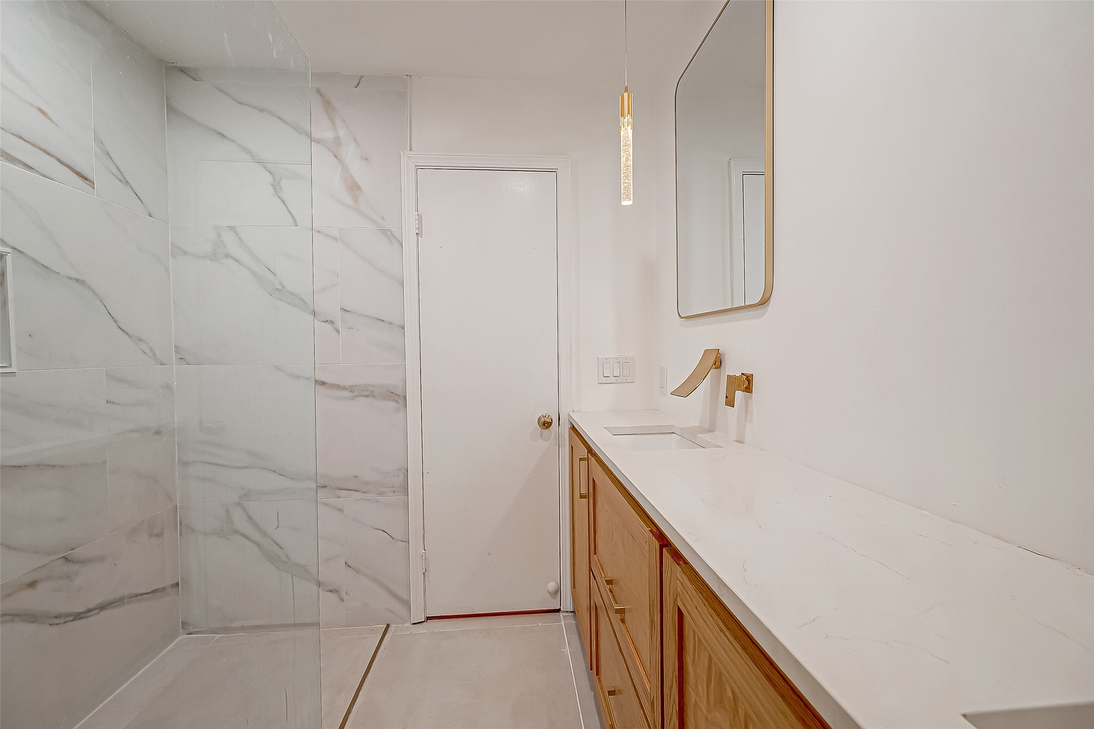 7497 Brompton Street, Unit 7497 Houston, TX 77025 - Photo 13 of 27 a bathroom with a sink and mirror