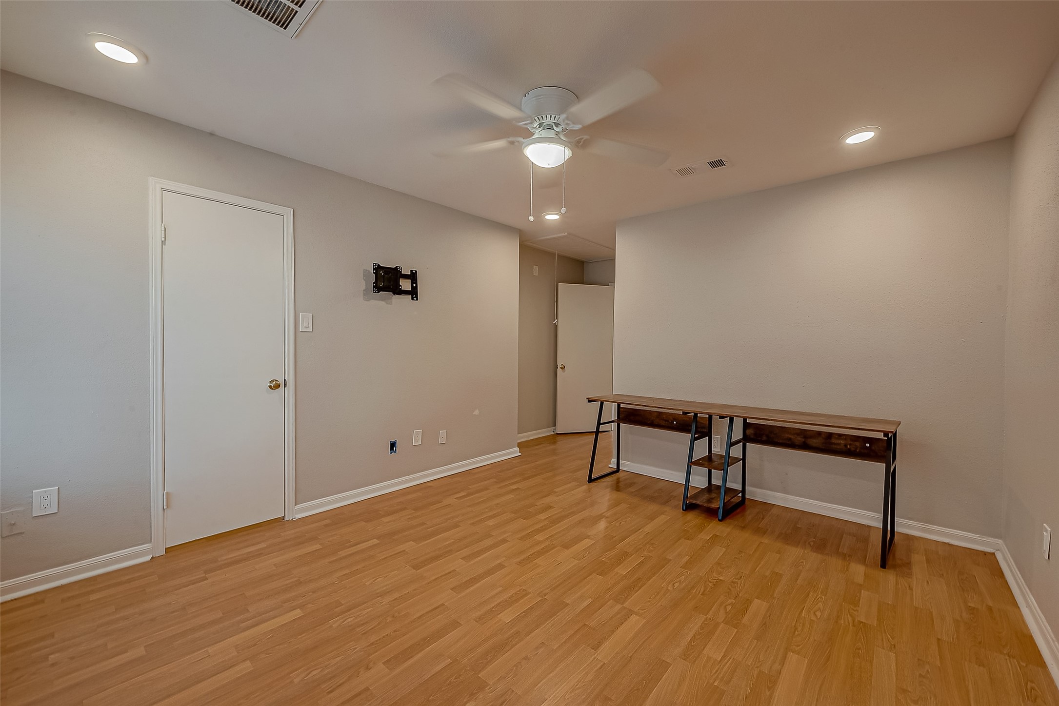 7497 Brompton Street, Unit 7497 Houston, TX 77025 - Photo 14 of 27 a view of an empty room with wooden floor