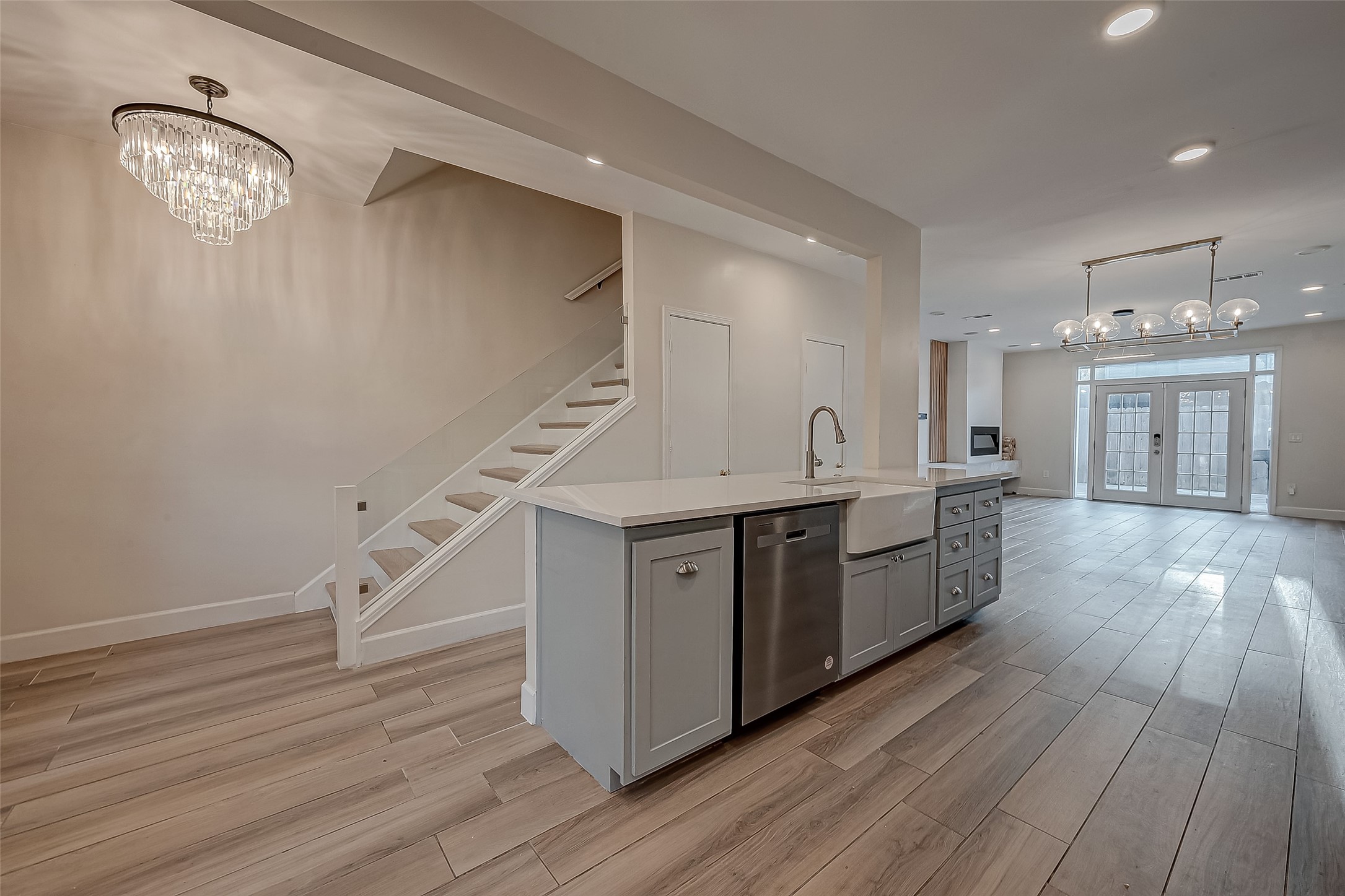 7497 Brompton Street, Unit 7497 Houston, TX 77025 - Photo 2 of 27 a kitchen with cabinets wooden floor and a clock