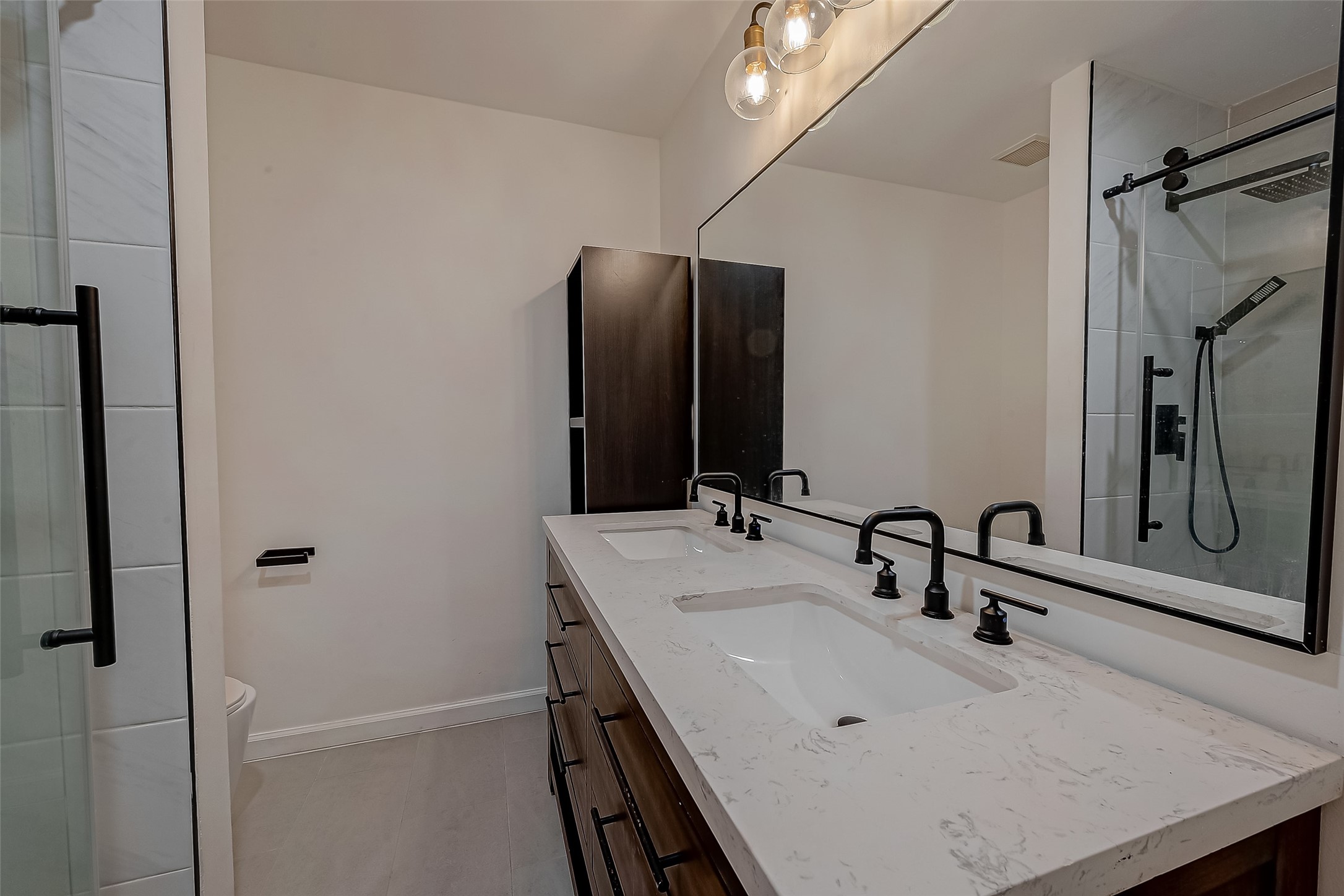 7497 Brompton Street, Unit 7497 Houston, TX 77025 - Photo 24 of 27 a bathroom with a sink and mirror