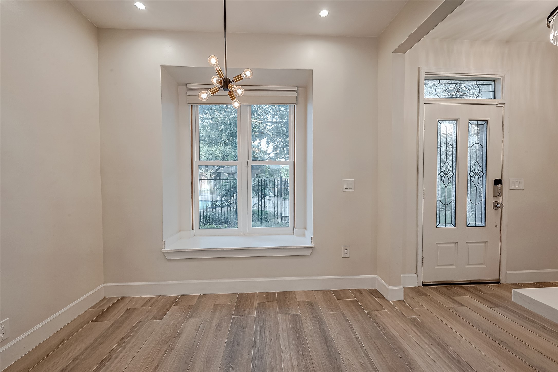 7497 Brompton Street, Unit 7497 Houston, TX 77025 - Photo 27 of 27 an empty room with wooden floor exposed radiator and windows