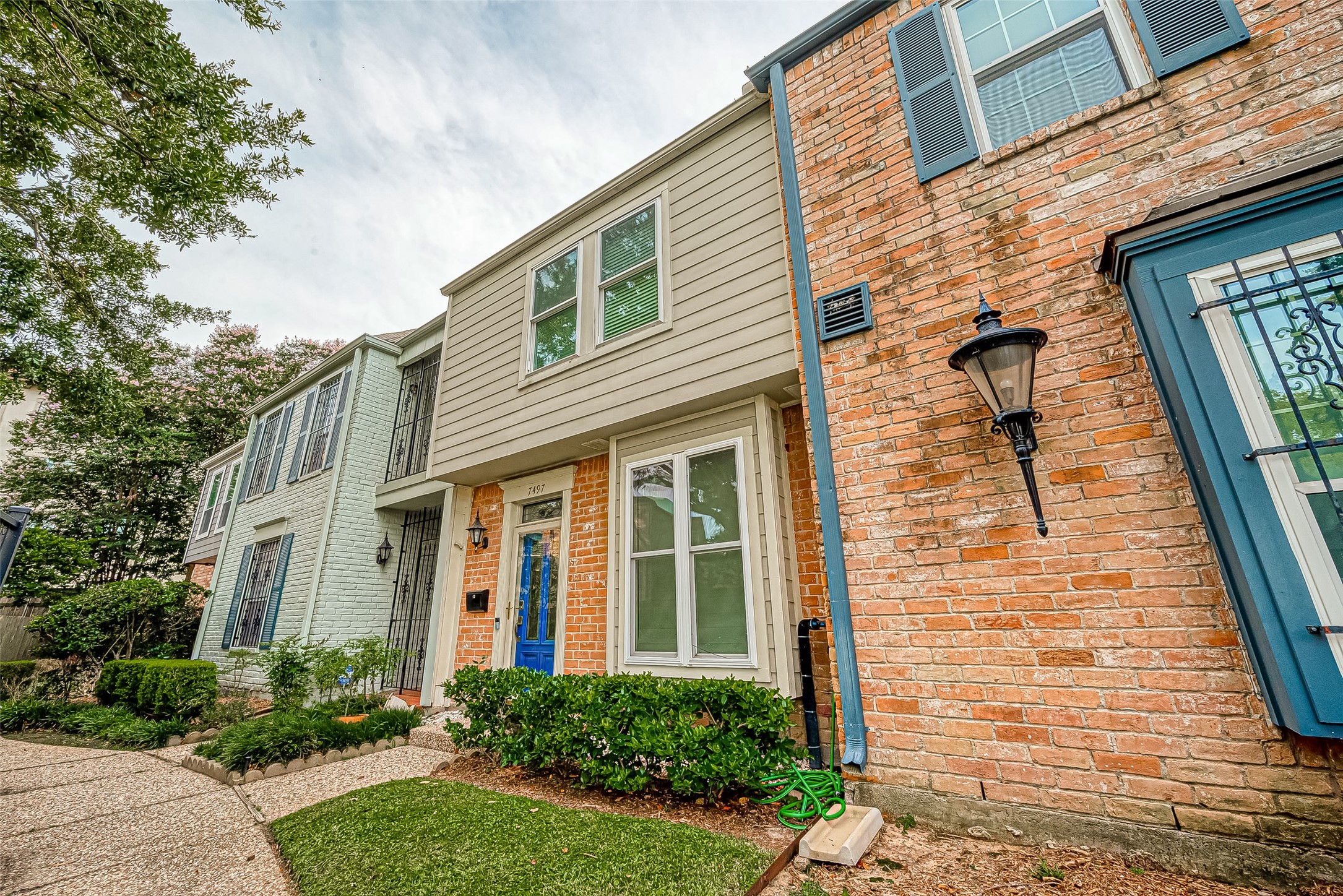 7497 Brompton Street, Unit 7497 Houston, TX 77025 - Photo 3 of 27 a view of a brick house with many windows