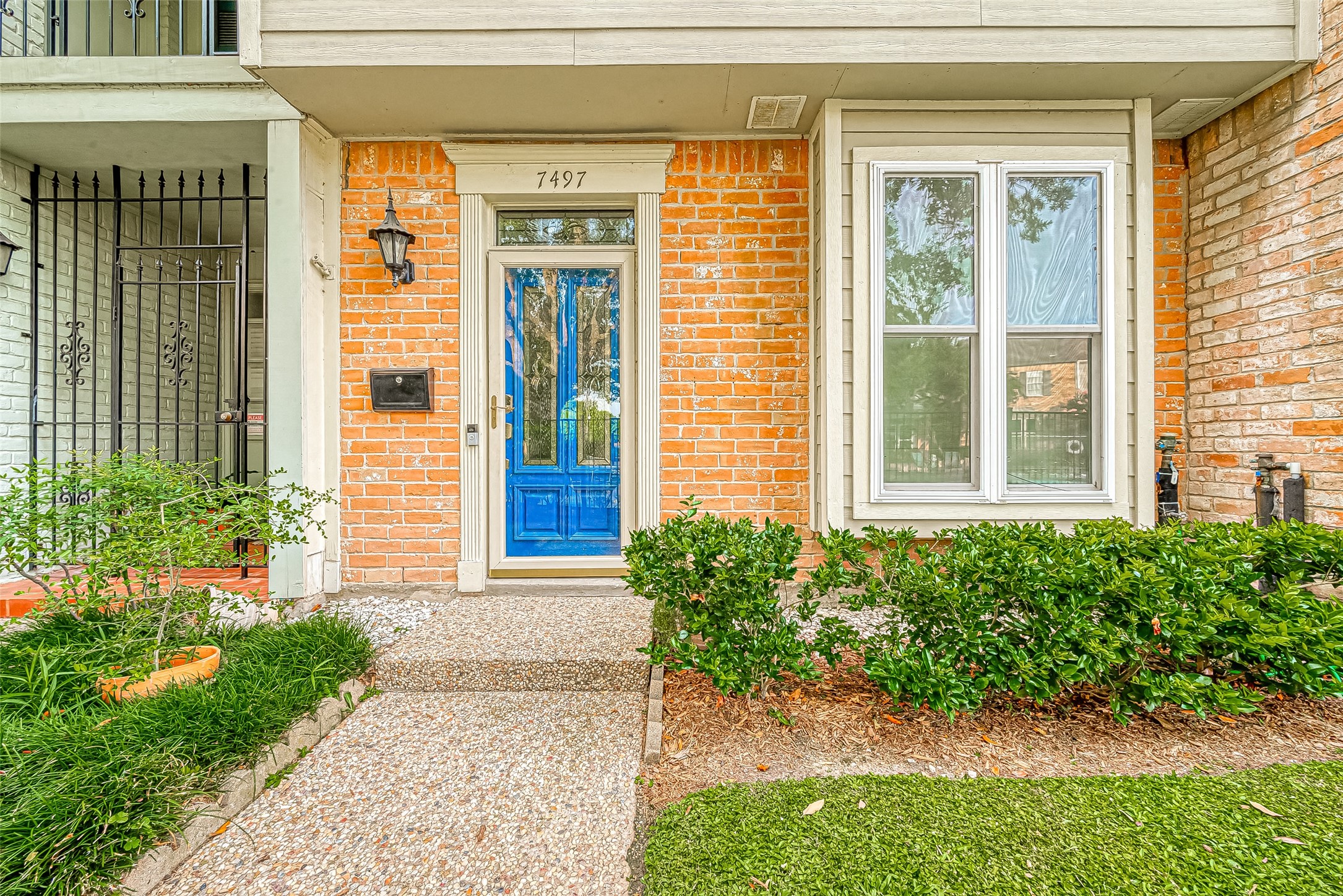 7497 Brompton Street, Unit 7497 Houston, TX 77025 - Photo 5 of 27 a front view of a house with a yard