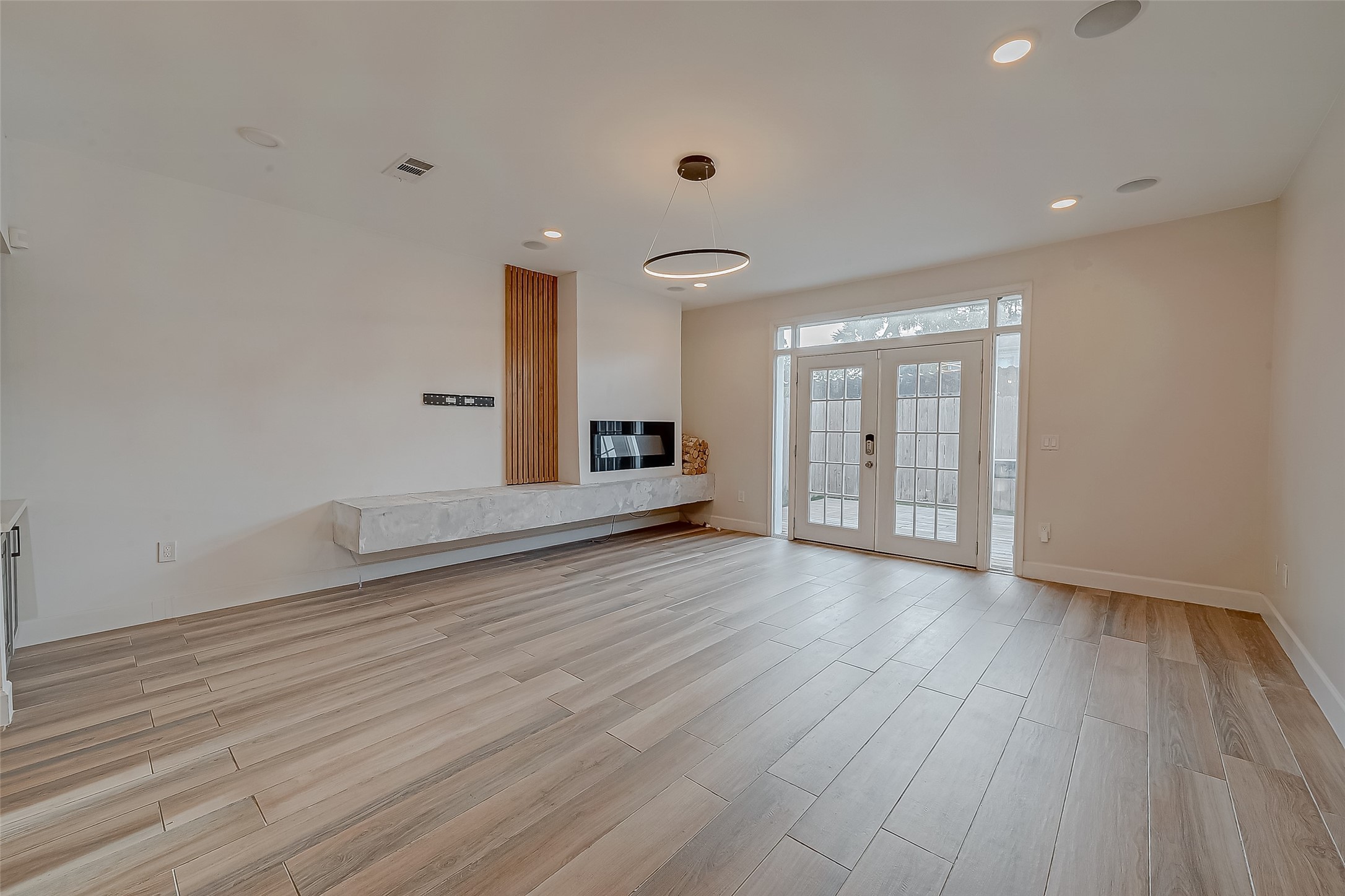 7497 Brompton Street, Unit 7497 Houston, TX 77025 - Photo 6 of 27 a view of an empty room with wooden floor