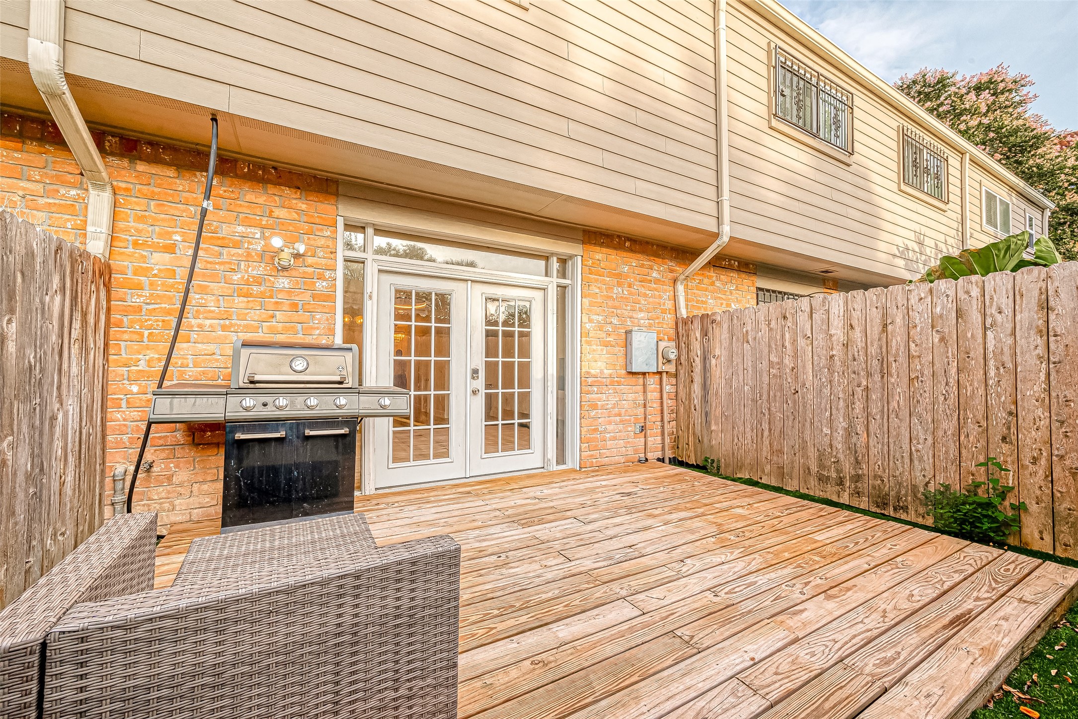 7497 Brompton Street, Unit 7497 Houston, TX 77025 - Photo 10 of 27 a view of a balcony with wooden floor and iron stairs