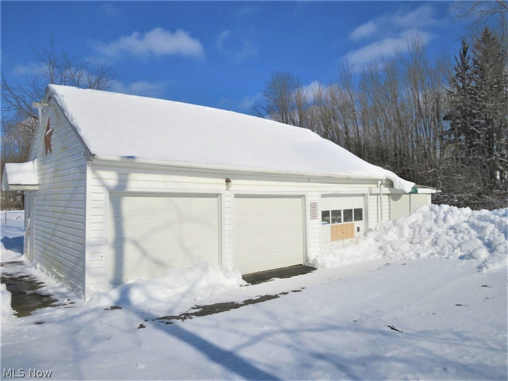 9499 Avon Belden Road North Ridgeville, OH 44039 - Photo 4 of 31 3 car detached garage (2 have remote openers), and theres an attached storage shed on the end as well