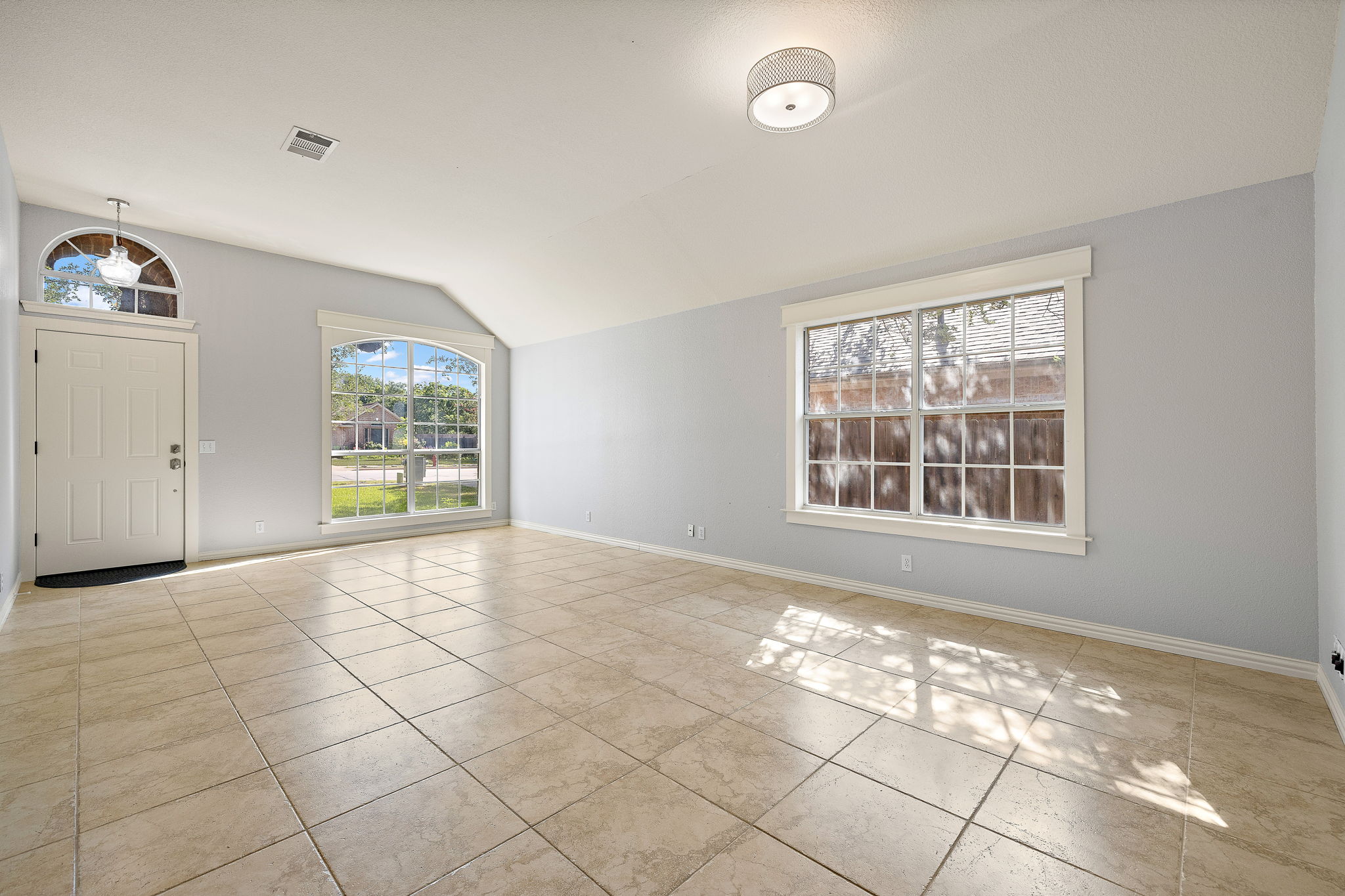 1102 Nelson Ranch Road Cedar Park, TX 78613 - Photo 6 of 37 The open living area features vaulted ceilings, ample natural light, and elegant tile flooring.