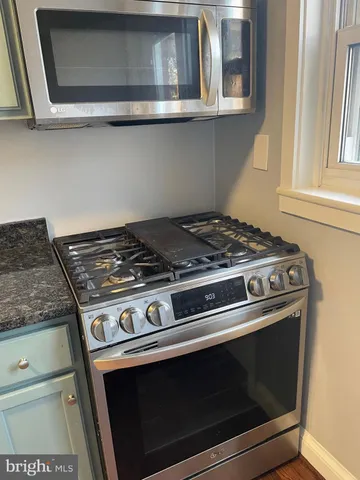 a stove top oven sitting inside of a kitchen